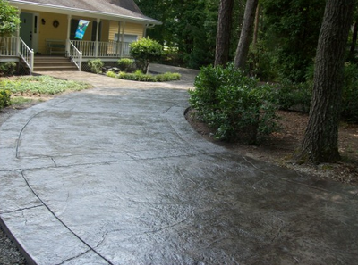 Textured and stained dark brown driveway.