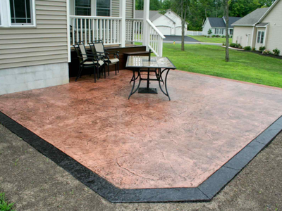 Simple textured concrete patio, with a dark brown stamped edge