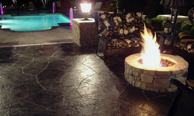 Plain concrete pool deck, with a decorative stamped concrete patio and built in fire pit.