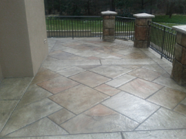 Multi-brown colored stamped concrete around a large front porch.